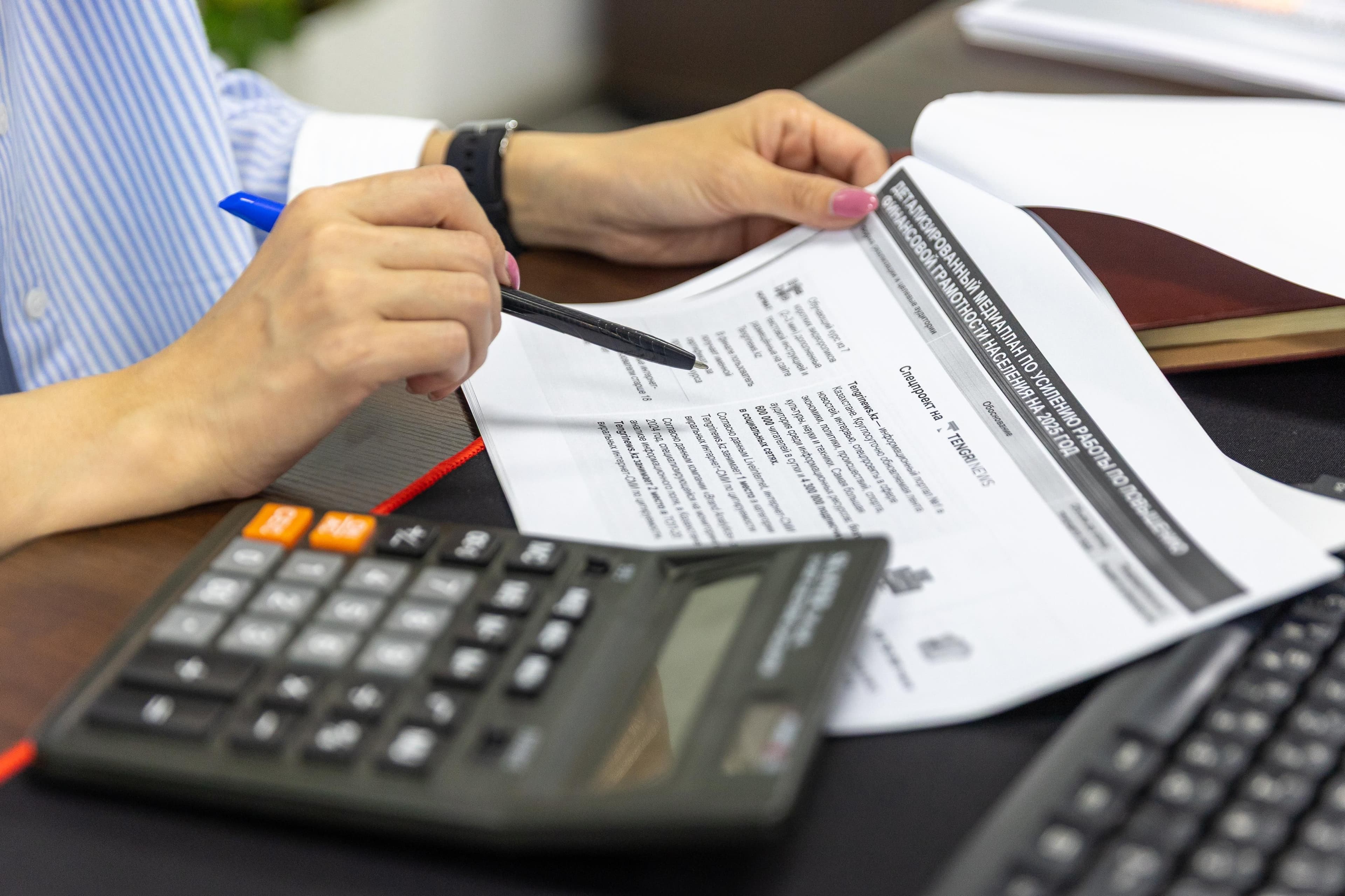 Finance professional reviewing multi-entity accounting records and supporting documents
