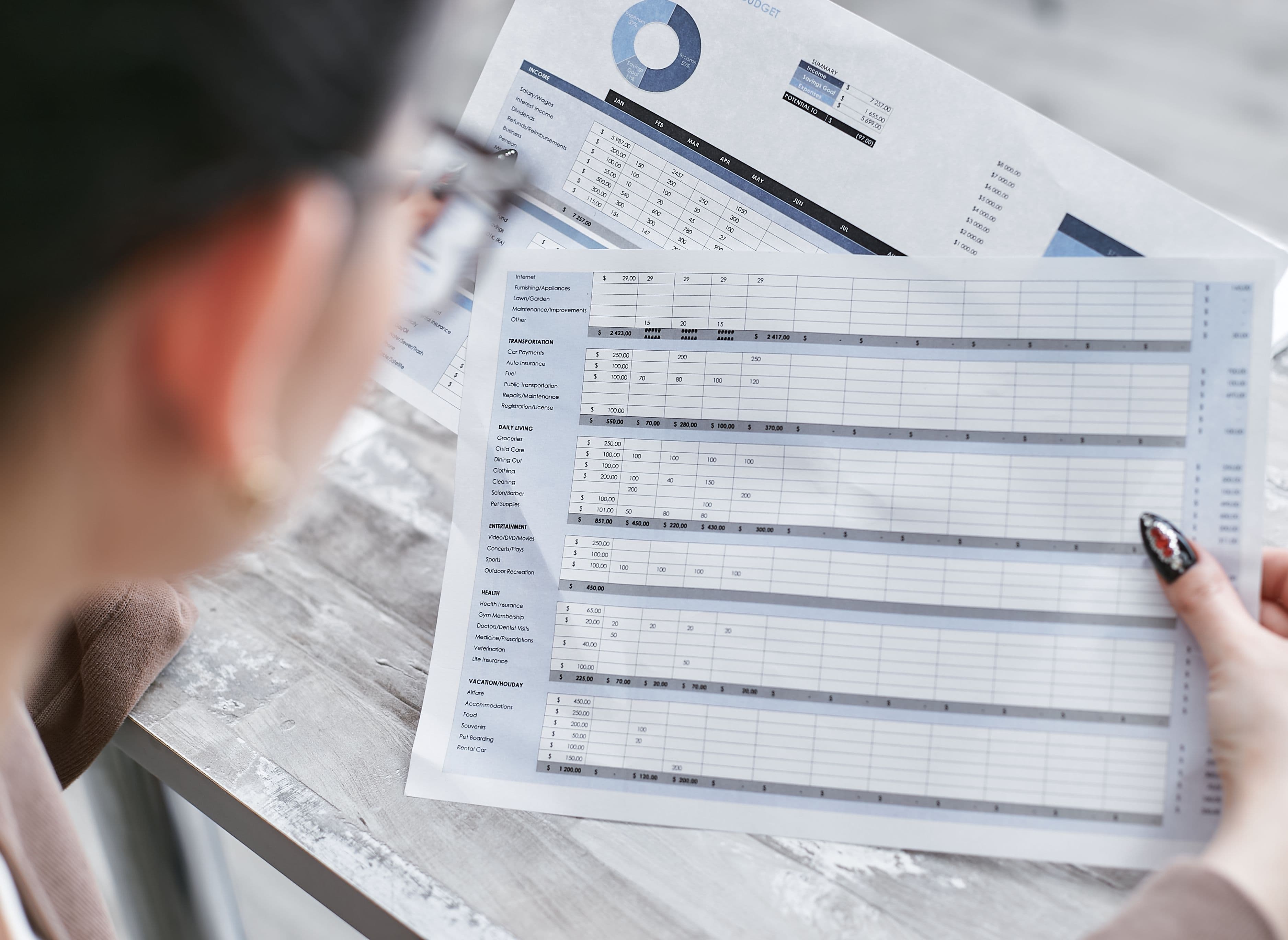 Finance professional reviewing a reconciliation schedule and financial records