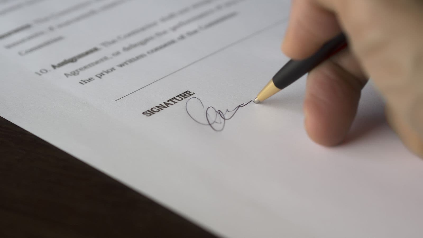 Calculator and invoice on a desk representing FloQast pricing and annual contract cost research