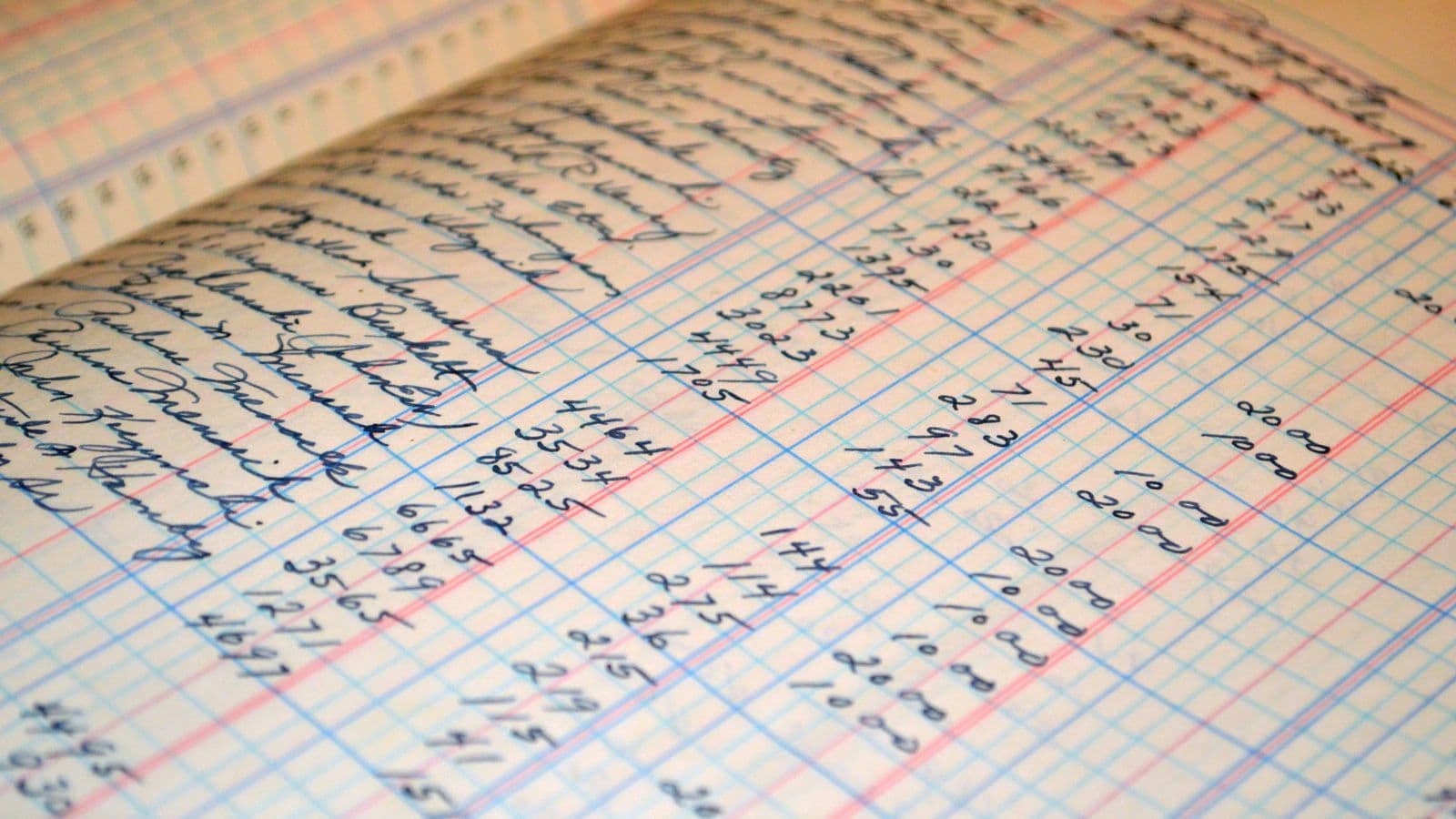 Close-up of a vintage handwritten ledger detailing financial records and account reconciliations