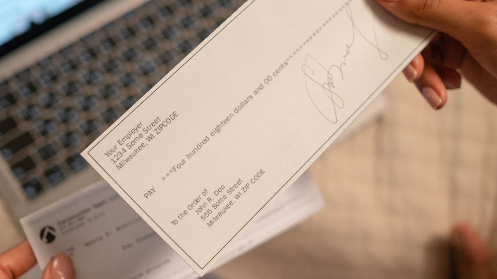 A bookkeeper comparing a printed bank statement against a general ledger cash account during a bank reconciliation
